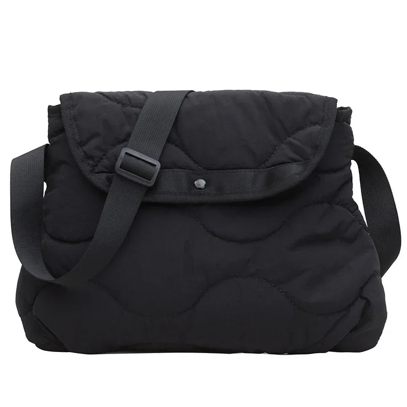 Borsa a tracolla nera imbottita, design trapuntato, chiusura con bottone, cinturino regolabile. Accessorio moda donna elegante e pratico.