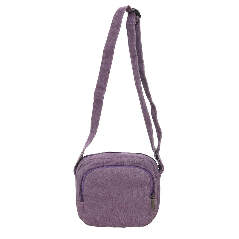 Borsa a tracolla viola in tessuto, design compatto, chiusura con zip, ideale per uso quotidiano. Accessorio moda donna, stile casual.