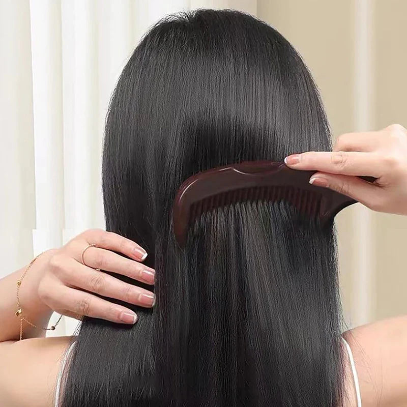Donna pettina capelli lunghi e lisci con pettine marrone. Cura dei capelli, pettine antistatico, styling capelli lisci, accessori bellezza.