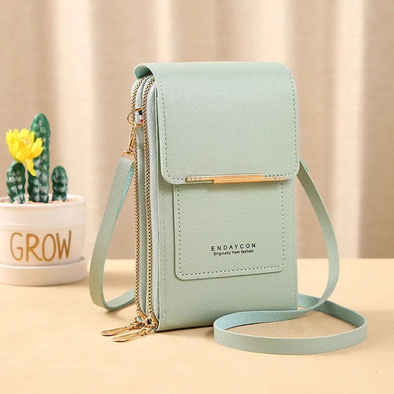 Borsa a tracolla verde menta in pelle sintetica con doppia cerniera, design compatto, ideale per smartphone. Accessorio moda elegante e pratico.