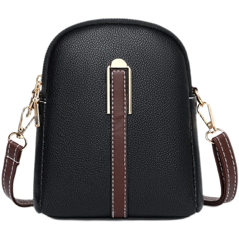 Borsa a tracolla in pelle nera con dettagli marroni e chiusura dorata, design elegante e compatto, ideale per moda femminile e accessori.