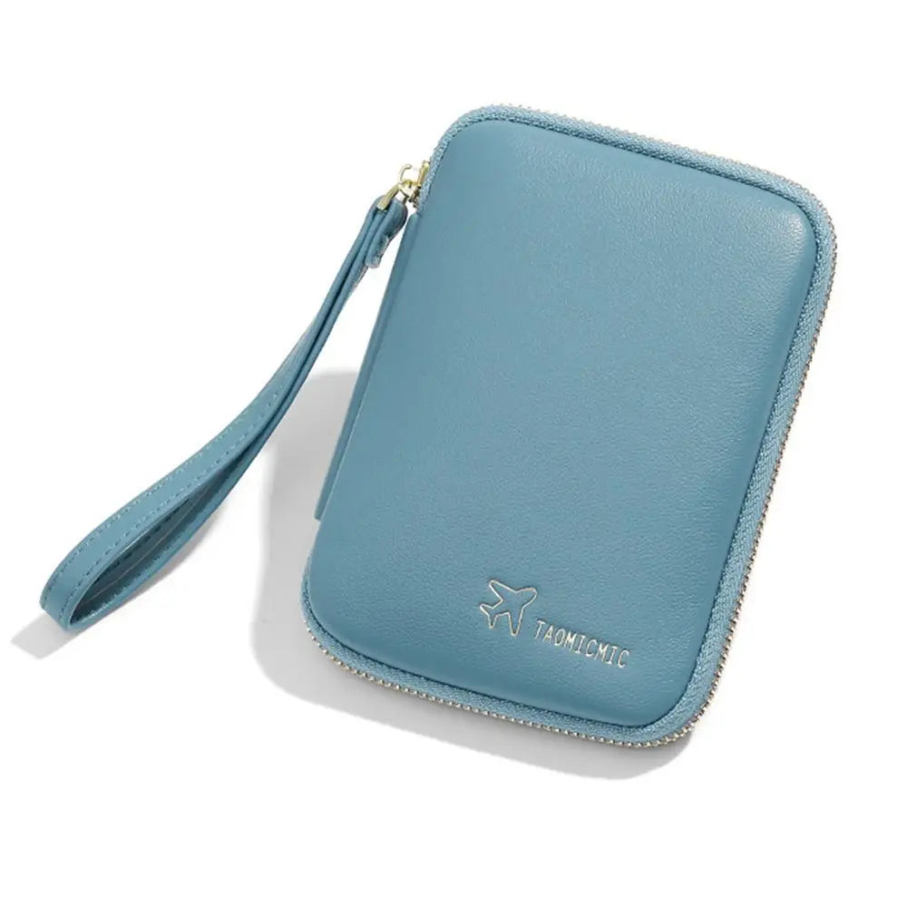 Custodia portafoglio da viaggio in pelle blu con cerniera e cinturino, logo aereo. Accessorio elegante e funzionale per documenti e carte.