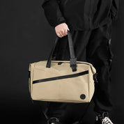 Borsa a tracolla beige unisex, design moderno, manici neri, ideale per viaggi e lavoro. Materiale resistente, stile casual ed elegante.