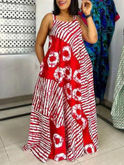 Abito lungo estivo da donna in tessuto batik rosso e bianco, design a righe e cerchi, senza maniche, ideale per moda casual e vacanze.