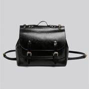 Zaino in pelle nera elegante con fibbie dorate, design classico, ideale per lavoro e viaggio. Accessorio moda unisex di alta qualità.