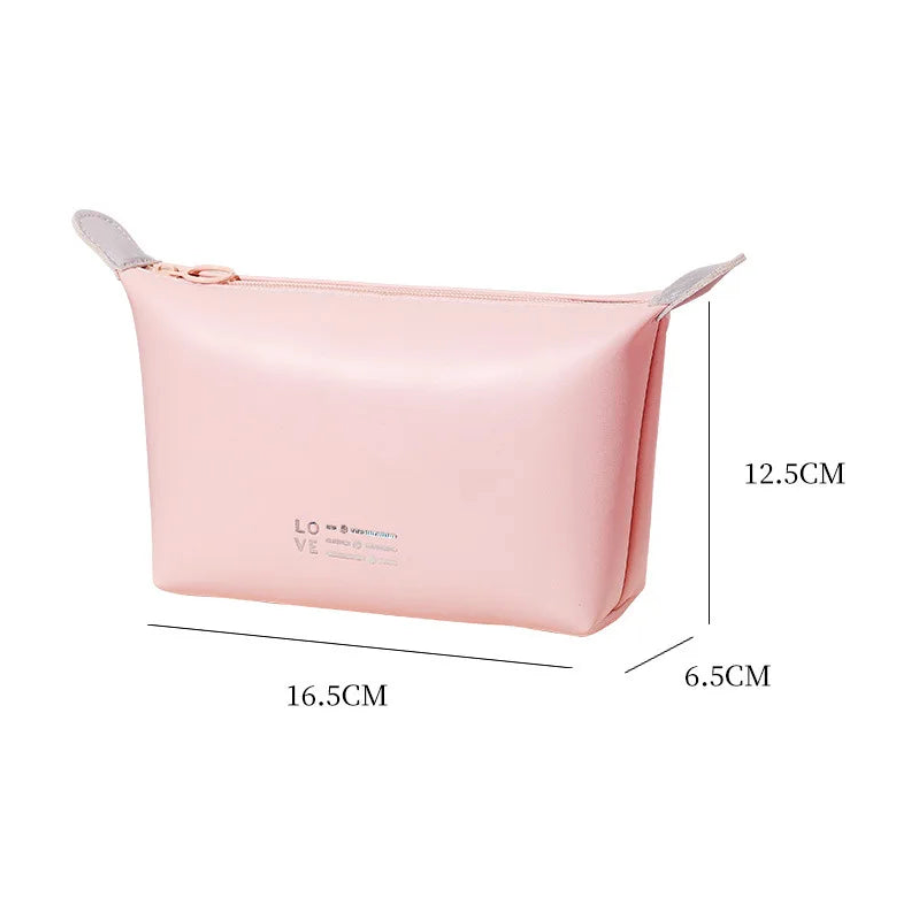 Astuccio cosmetico rosa in silicone, dimensioni 16.5x6.5x12.5 cm, con cerniera. Ideale per trucco, accessori viaggio, organizer borsa.