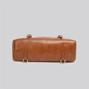 Borsa a tracolla in pelle marrone, design cilindrico, con anelli metallici dorati. Elegante accessorio moda donna, perfetto per ogni occasione.