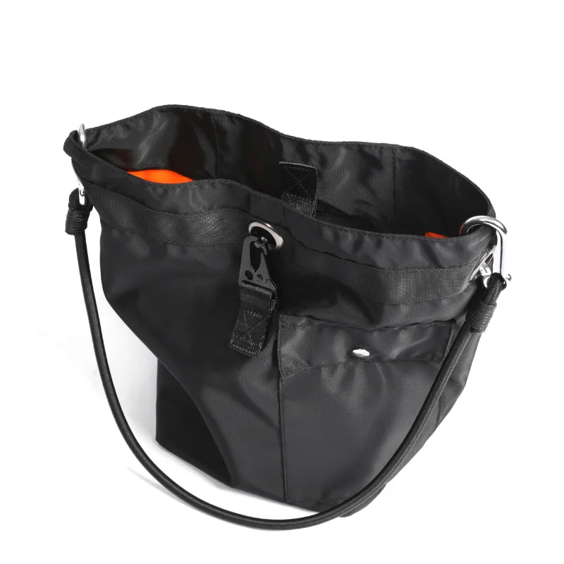 Borsa a tracolla nera in nylon con interno arancione, tasca frontale e chiusura a bottone. Design moderno, ideale per uso quotidiano e shopping.