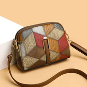 Borsa a tracolla donna in pelle patchwork multicolore, design geometrico, chiusura zip, elegante e moderna, perfetta per ogni occasione.