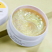 Maschera occhi Jomtam in gel trasparente con glitter dorati, confezione rotonda bianca, idratazione e luminosità per la pelle, cura occhi.