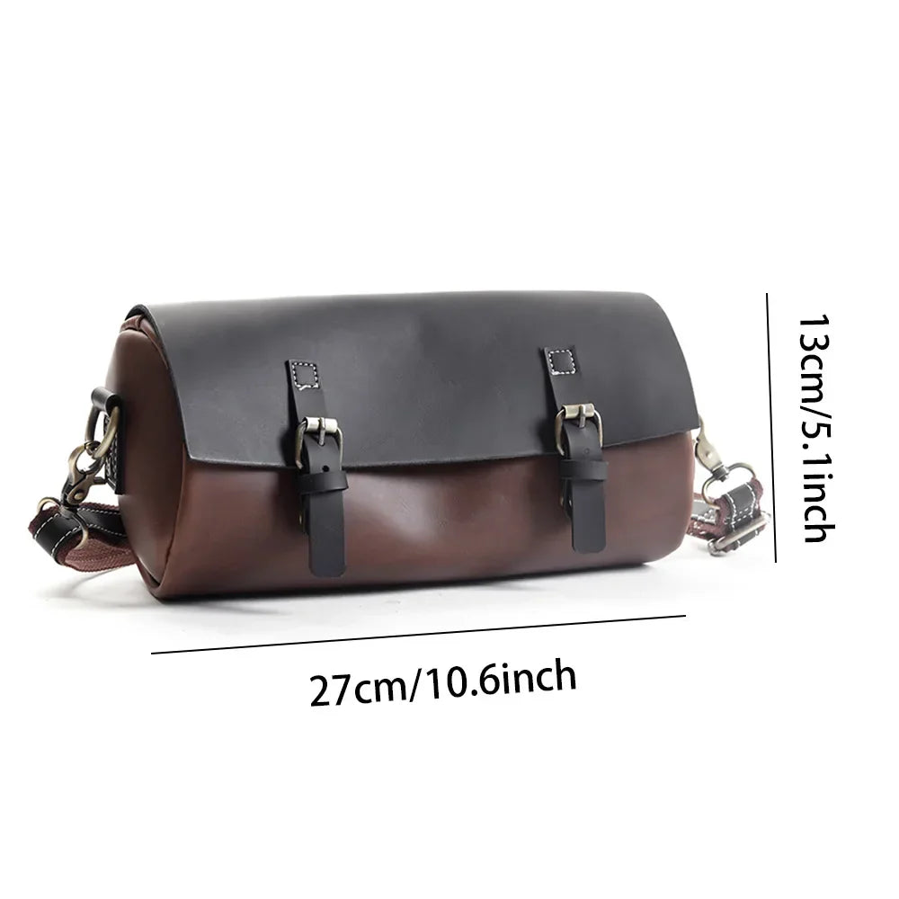 Borsa a tracolla in pelle bicolore nero e marrone, dimensioni 27x13 cm, con fibbie decorative e tracolla regolabile. Accessorio moda elegante.