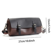 Borsa a tracolla in pelle bicolore nero e marrone, dimensioni 27x13 cm, con fibbie decorative e tracolla regolabile. Accessorio moda elegante.