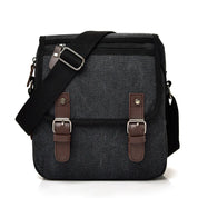 Borsa a tracolla in tela nera con fibbie marroni, tasca frontale con zip, ideale per uomo, stile casual, resistente e pratica per l'uso quotidiano.