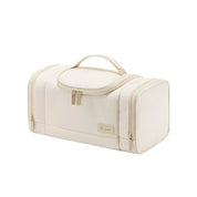 Borsa da viaggio beige con manico, design rettangolare, doppia cerniera. Ideale per organizzare accessori e cosmetici. Elegante e funzionale.