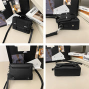 Borsa a tracolla nera in pelle, design moderno e minimalista, con dettagli metallici. Perfetta per moda urbana e look casual.