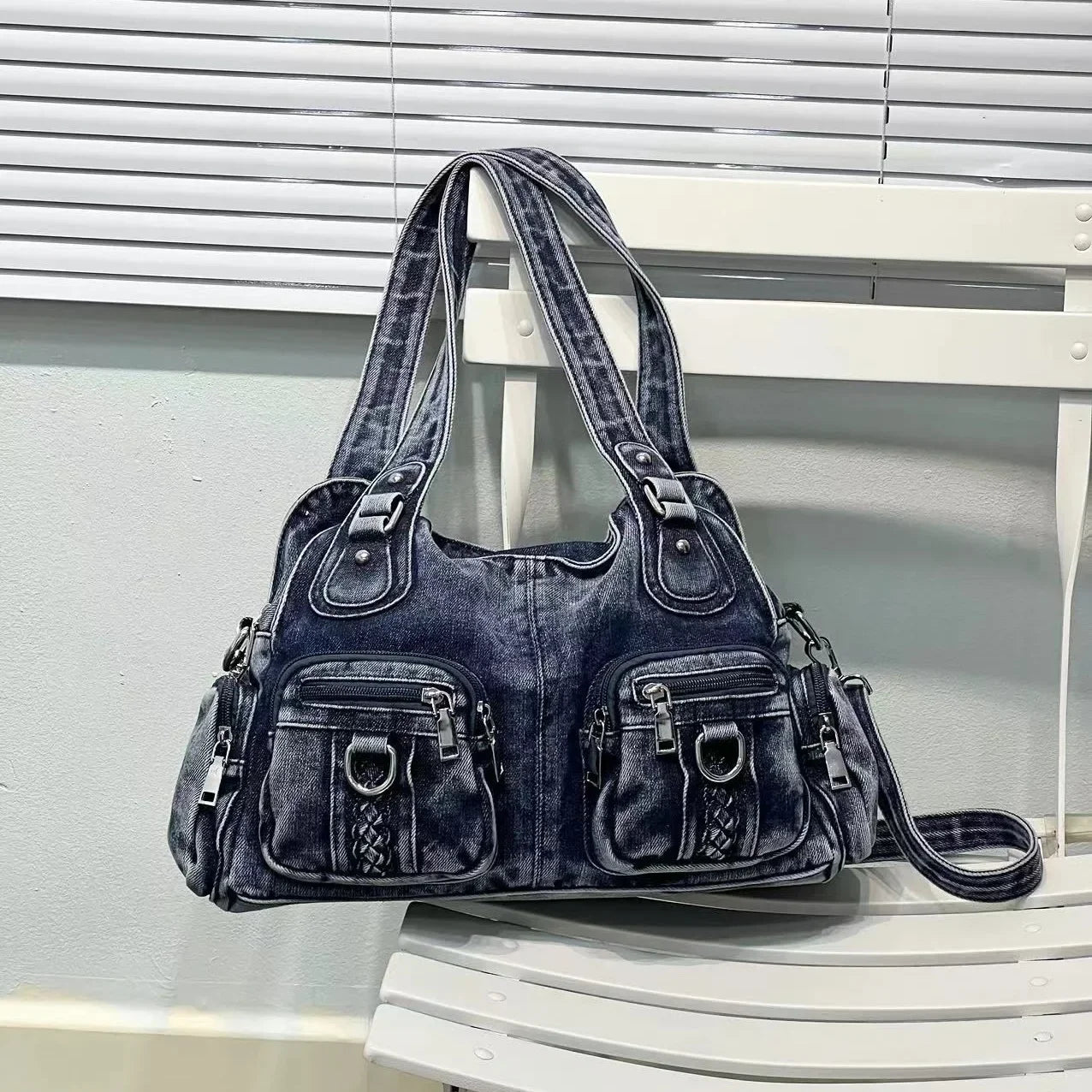 Borsa a spalla in denim blu scuro con tasche multiple e dettagli in metallo, design casual e versatile, perfetta per uso quotidiano e moda urbana.