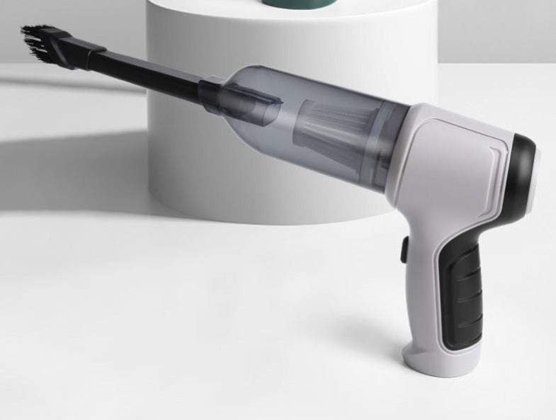 Aspirapolvere portatile senza fili su sfondo bianco, design ergonomico, ideale per pulizia auto e casa. Tecnologia avanzata, compatto ed efficiente.