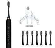 Spazzolino elettrico nero con setole intercambiabili, sei testine di ricambio e cavo di ricarica USB. Accessorio per igiene orale avanzata.