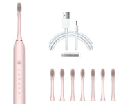 Spazzolino elettrico rosa con setole intercambiabili, caricatore USB e sette testine di ricambio. Accessorio per igiene orale avanzata.