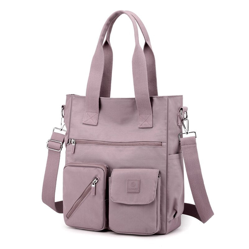 Borsa a tracolla in nylon rosa con tasche multiple, design moderno e funzionale, ideale per donna, perfetta per lavoro e tempo libero.