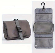 Gray travel toiletry bag with hanging hook, multiple mesh compartments, and secure buckle closure. Ideal for organizing toiletries on the go.