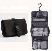 Black hanging travel toiletry bag with hook, multiple mesh compartments, and secure buckle closure. Ideal for organizing toiletries on the go.
