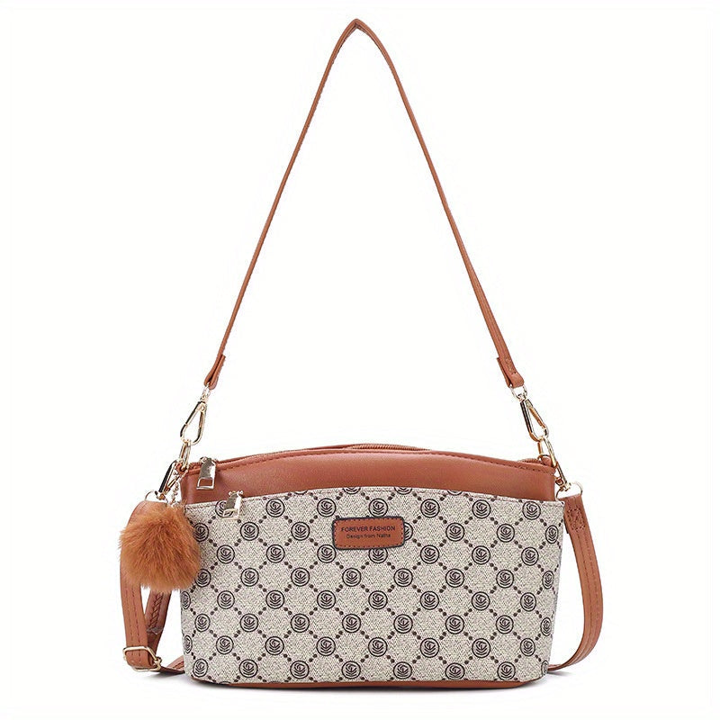 Borsa a tracolla in pelle marrone con motivo geometrico, ciondolo peloso, chiusura con zip, ideale per moda donna, accessorio elegante e versatile.