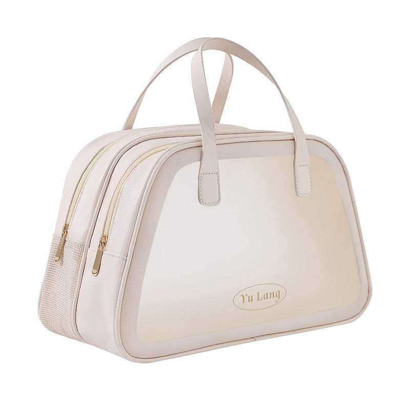 Borsa da viaggio beige con doppia cerniera, manici superiori e design elegante. Perfetta per viaggi, weekend e uso quotidiano.