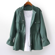 Giacca verde militare da donna con coulisse in vita, tasche frontali e chiusura a zip, appesa su gruccia. Perfetta per look casual e autunnali.