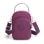 Borsa a tracolla viola in nylon, compatta e resistente, con tasca frontale e cerniera. Ideale per viaggi e uso quotidiano.