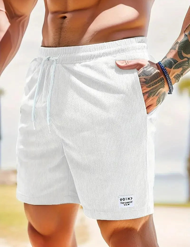 Shorts da uomo bianchi, tessuto a coste, con laccio in vita e tasche laterali. Ideali per l'estate e la spiaggia. Stile casual e moderno.