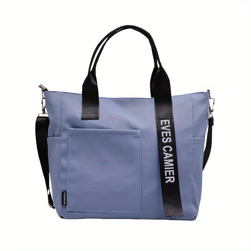 Borsa a tracolla unisex blu con manici neri, tasca frontale e cinturino con scritta "EVES CAMEIR". Design moderno, ideale per uso quotidiano.