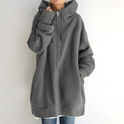 Felpa oversize con cappuccio grigio, zip frontale, maniche lunghe, stile casual. Ideale per moda autunnale e invernale.