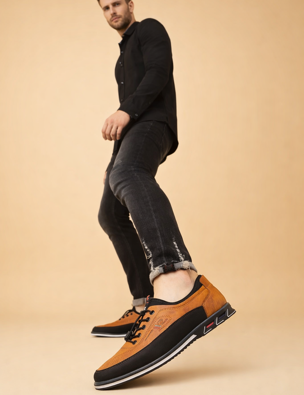 polish-male-model-wearing-orange-black-leather-sneakers-european-studio-posed-shot.png