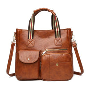 Borsa a tracolla in pelle marrone con manici a righe, tasche frontali con zip e bottoni. Elegante e pratica per donna. Accessorio moda versatile.