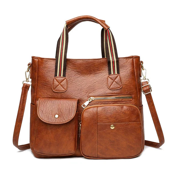 Borsa a tracolla in pelle marrone con manici a righe, tasche frontali con zip e bottoni. Elegante e pratica per donna. Accessorio moda versatile.