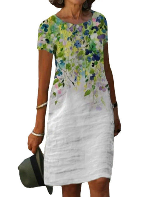 Abito estivo donna, manica corta, stampa floreale colorata su sfondo bianco, casual elegante, perfetto per occasioni estive e giornate calde.