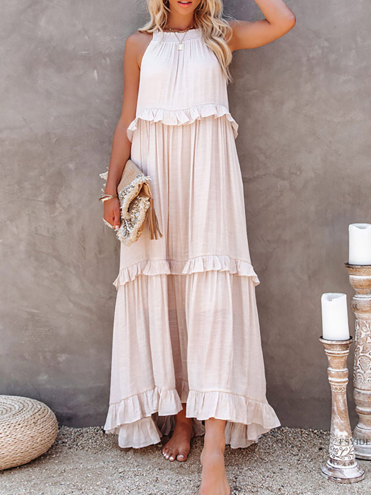 Abito lungo estivo donna in cotone bianco, senza maniche, con volant. Perfetto per eventi casual o eleganti. Accessoriato con borsa intrecciata.