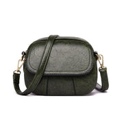 Borsa a tracolla verde in pelle sintetica, design compatto, chiusura a zip, dettagli dorati, ideale per moda donna, accessorio elegante e pratico.