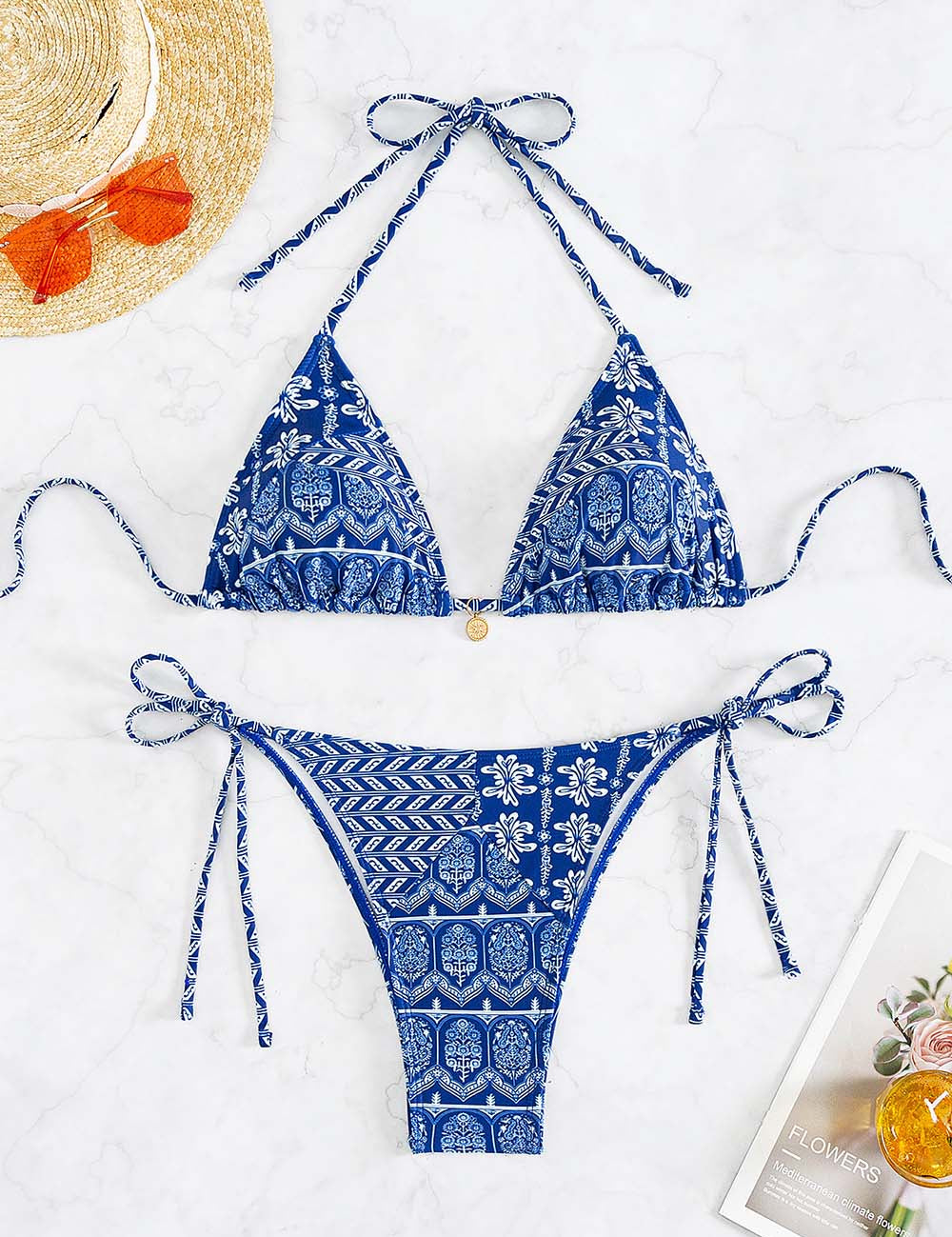 Bikini blu a triangolo con stampa floreale, laccetti regolabili, su sfondo bianco. Perfetto per l'estate e la spiaggia. Cappello e rivista inclusi.